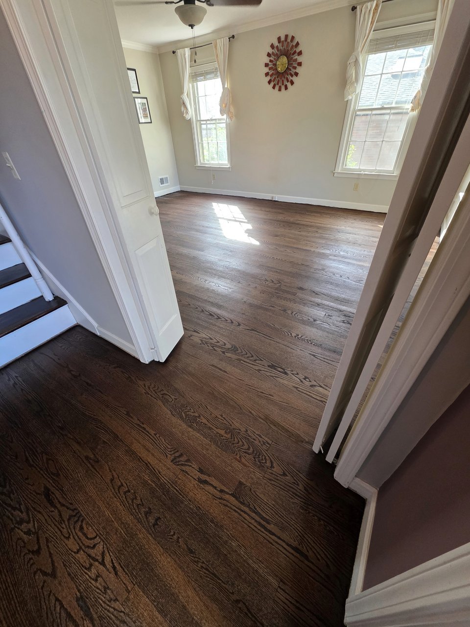 Finished wood floor viewed through a doorway