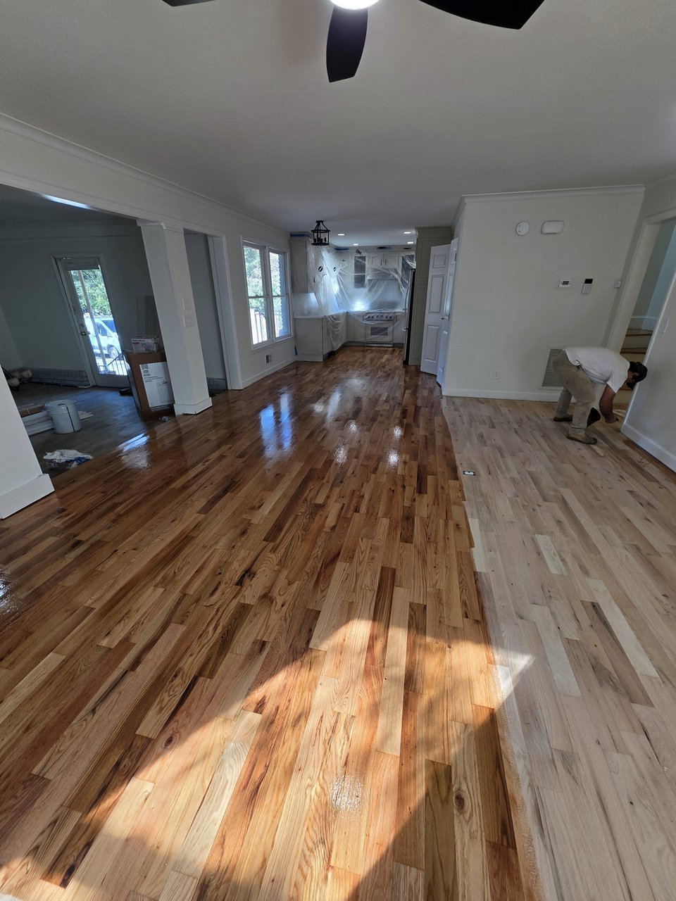 Finished wood floor across the same open living area from a different viewpoint