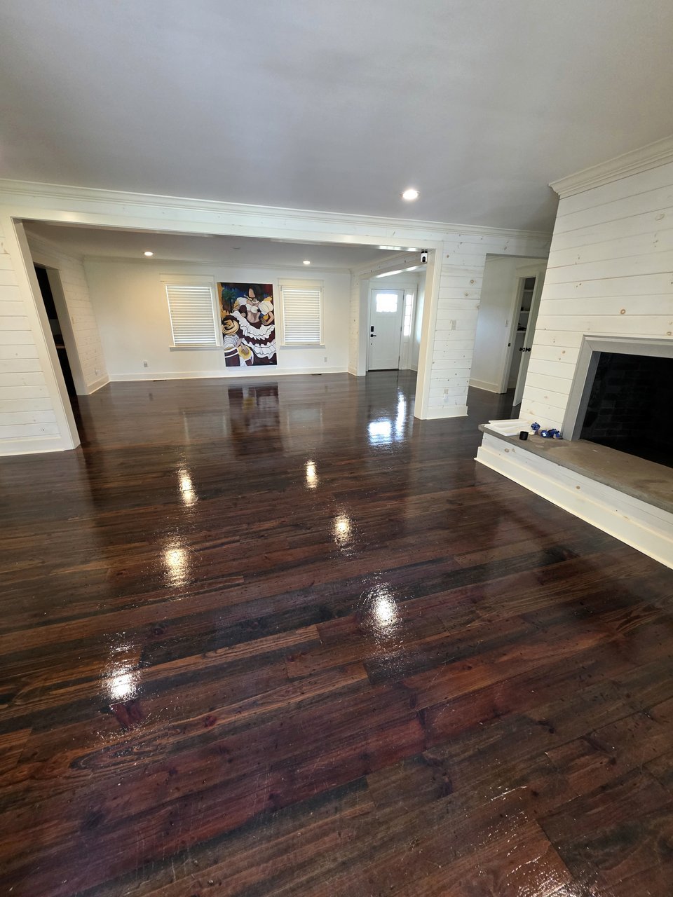 Wood floor reflecting ceiling lights in a living area
