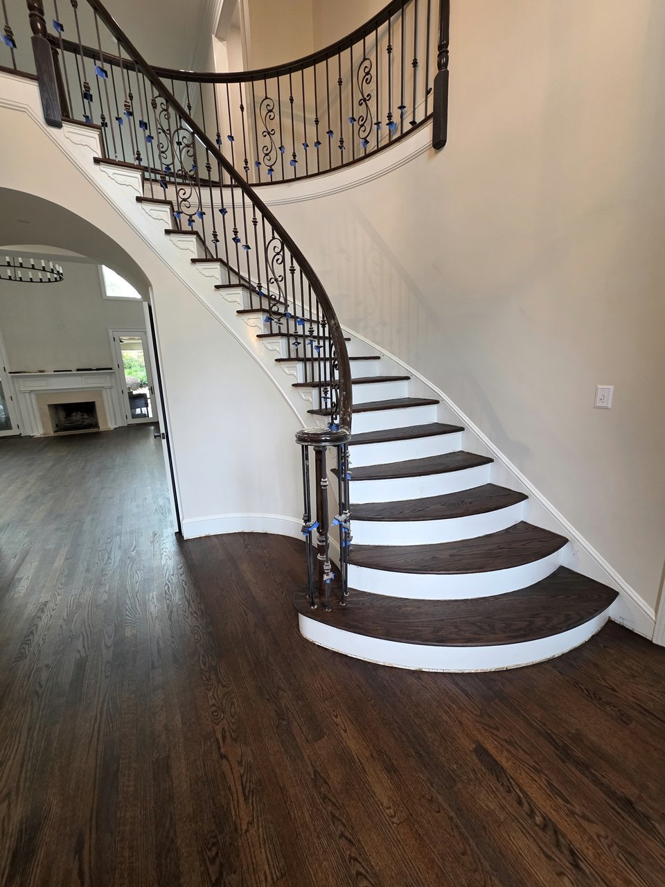 Curved staircase with dark finished wood treads